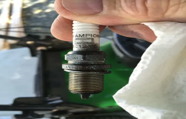 where is the spark plug located on a lawn mower